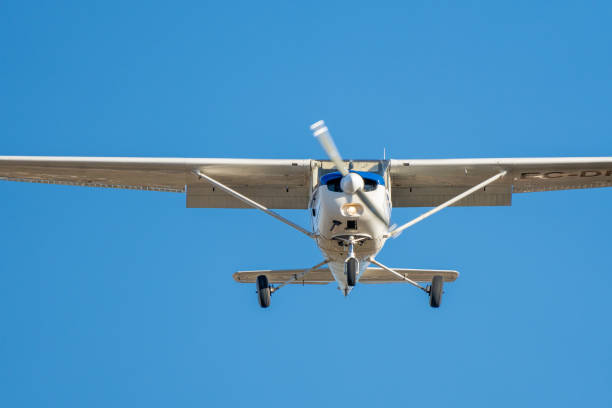 istock Small plane flying with sunset light in a clear sky 1382060465