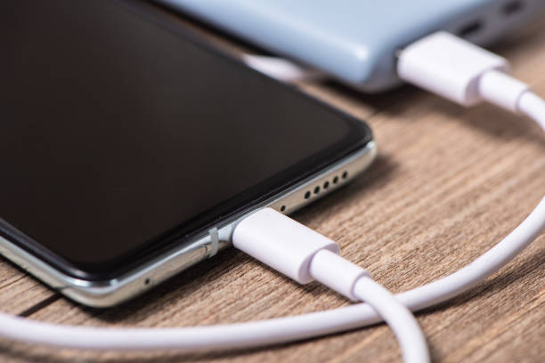 istock Charging a smartphone via a USB cable and a power supply on table 1382070006