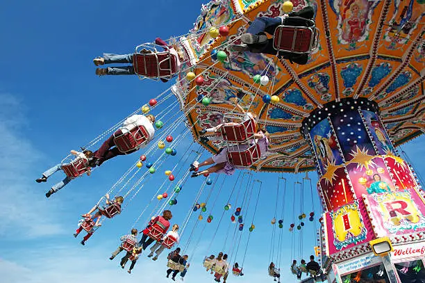 Photo of Families at the fair on a swing ride