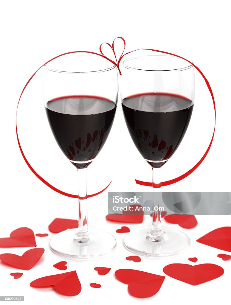 Romantic holiday celebration Romantic holiday drink, celebration of valentine's day, red wine with hearts ornament & ribbon decoration, isolated on white background Alcohol - Drink Stock Photo
