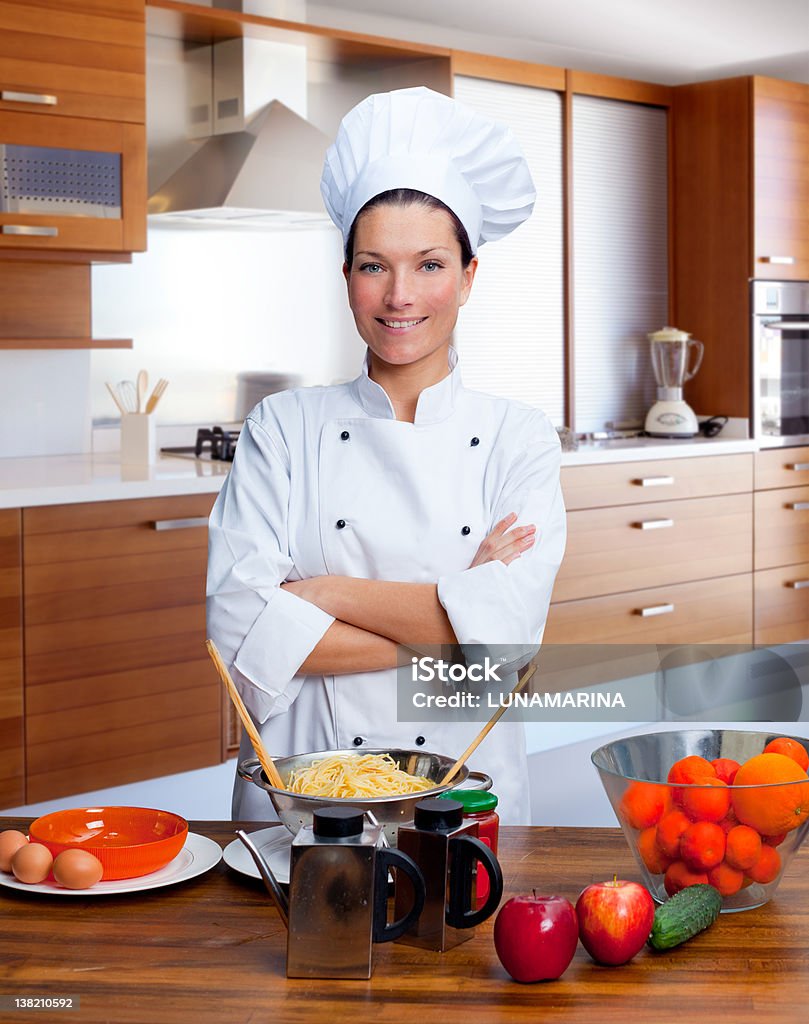 Chef woman portrait in the kitchen Chef woman portrait with white uniform in the kitchen 20-29 Years Stock Photo