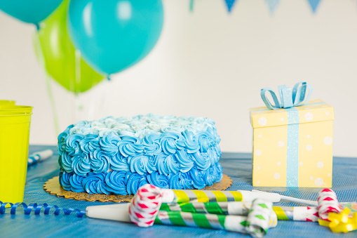 Blue birthday cake and decoration on table