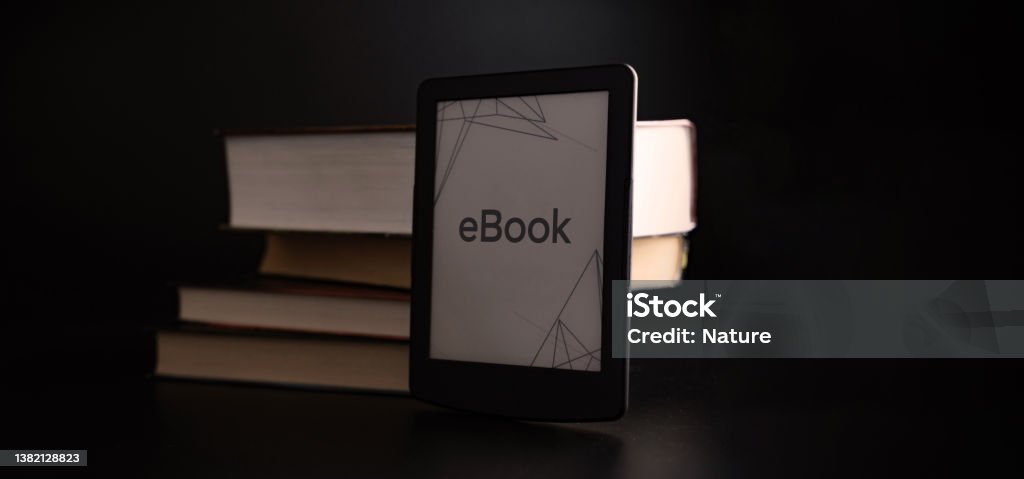 Readers. Digital e book, library reader tablet with books on dark background. Ebook, e learning electronic internet mobility concept. Readers. Digital e book, library reader tablet with books on dark background. Ebook, e learning electronic internet mobility concept Book Stock Photo