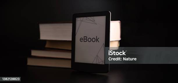 Readers Digital E Book Library Reader Tablet With Books On Dark Background Ebook E Learning Electronic Internet Mobility Concept Stock Photo - Download Image Now