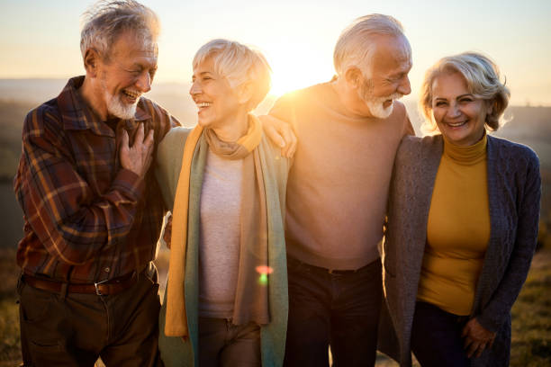 istock Happy mature couples talking while walking in autumn day. 1382129274