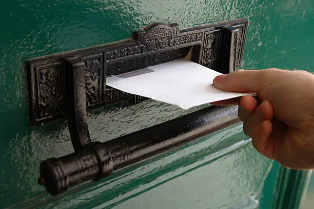 A postman delivers a letter.