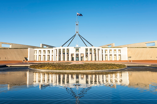 The national flag flutters on the Parliament House, Canberra, Australia.