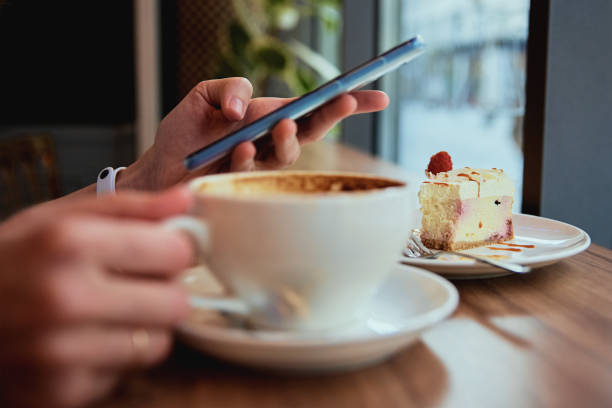istock Woman have breakfast at cafe, use smartphone at cafe 1382144961