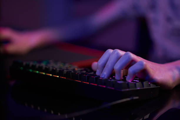 istock Gamer play computer game, use rgb neon colored keyboard 1382146067
