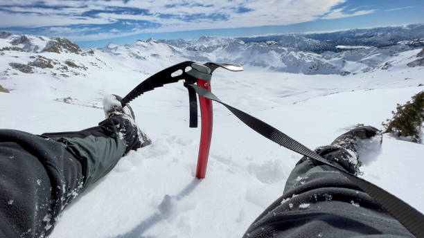 crossing and peaks with ice ax in mountains