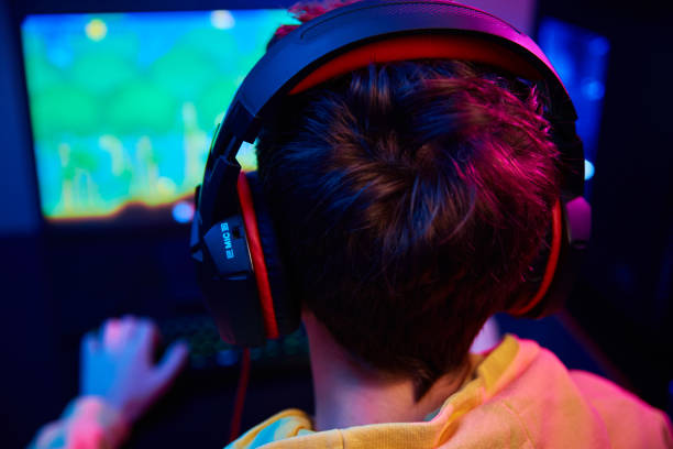 istock Gamer play computer game, use rgb neon colored keyboard 1382149931