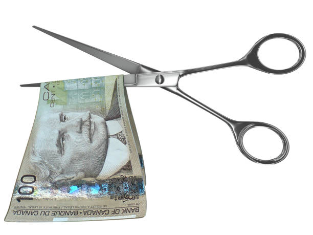 tesoura de crise monetária do dólar canadense - cutting currency scissors home finances - fotografias e filmes do acervo