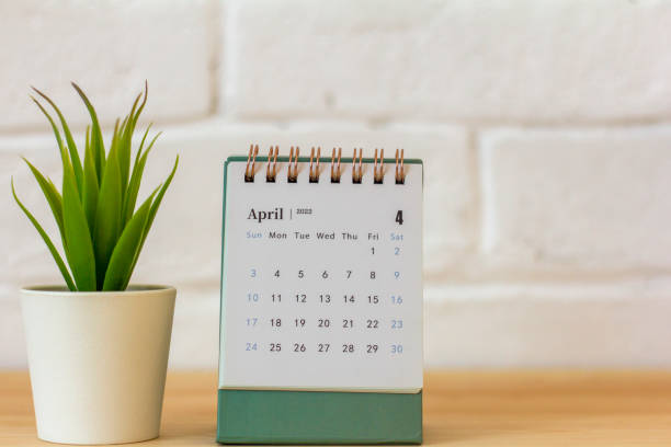istock Desktop calendar for April 2022 for planning on the table. 1382161105
