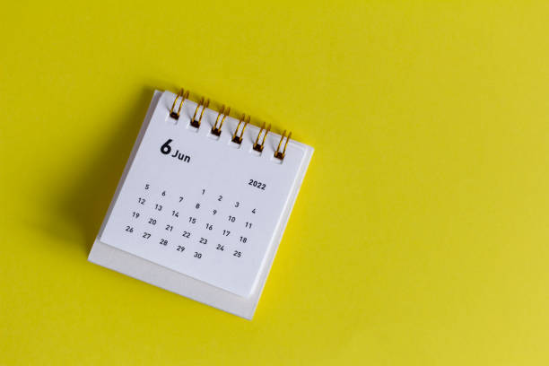 istock Desktop calendar for June 2022 on the table. 1382161106