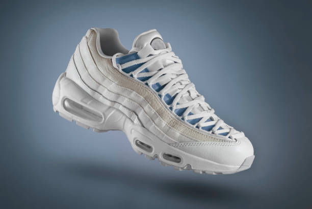 White sport sneaker on a blue gradient background, woman and men's fashion, sport shoe, sneakers, lifestyle, concept, product photo, blue accent White sport sneaker on a red gradient background, woman and men's fashion, sport shoe, sneakers, lifestyle, concept, product photo, blue accent nike air photos stock pictures, royalty-free photos & images
