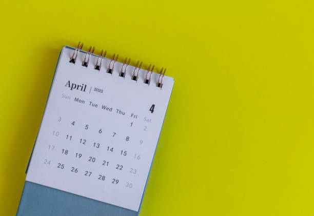 istock Desktop calendar for April 2022 for planning on the table. 1382167568