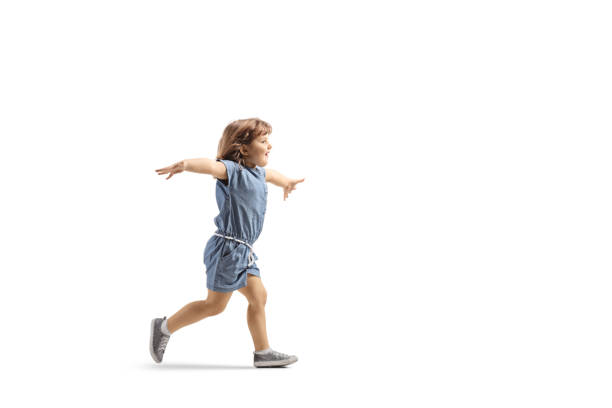 Full length profile shot of a happy little girl running and spreading arms Full length profile shot of a happy little girl running and spreading arms isolated on white background scoring run stock pictures, royalty-free photos & images