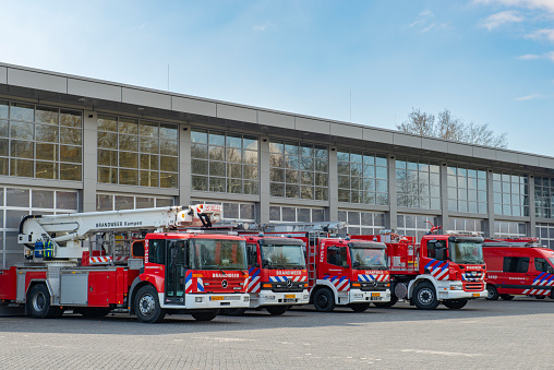 Fire engines of the Dutch fire department lined up in front of the fire station in Kampen in Overijssel, The Netherlands.
