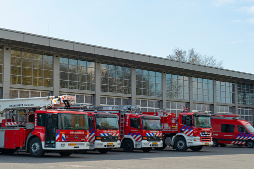 Annandale, Virginia, USA - October 19, 2023: Fire engines are seen behind the glass garage doors of Company 23, Annandale Volunteer Fire Department of the Fairfax County Fire Department.