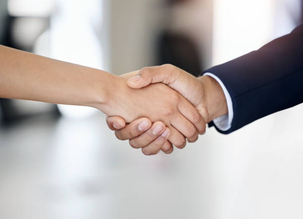 istock Shot of two unrecognizable businesspeople shaking hands at work 1382187523