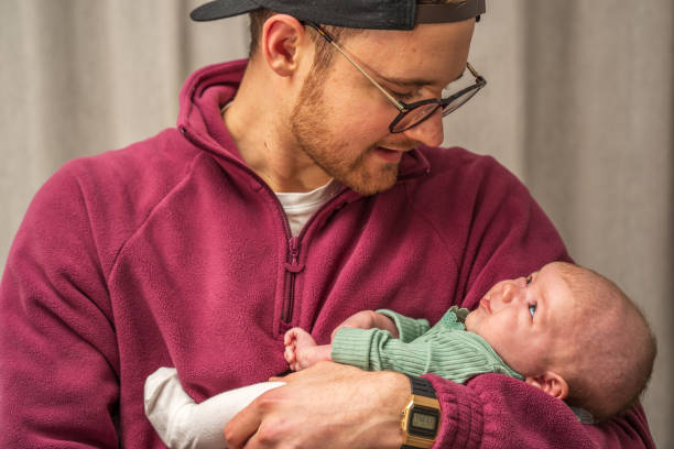 istock Father lovingly holding newborn daughter 1382188997