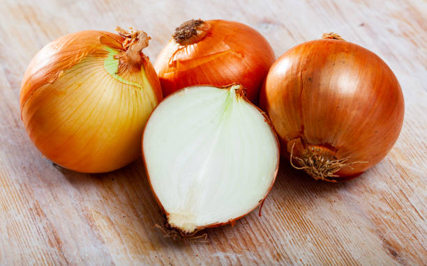 istock Image of cut onion bulbs on wooden background 1382193802