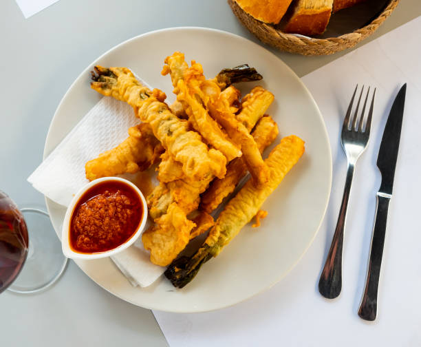 istock Delicious breaded calsot in tempura with the sauce Romesco 1382193809