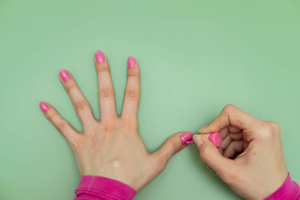 istock Woman painting her nails pink 1382198867