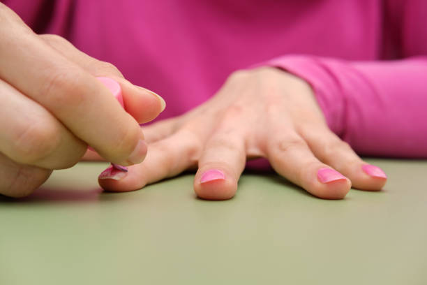 istock Woman painting her nails pink 1382198892
