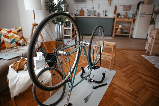 Photo of repairing bicycle in living room at home