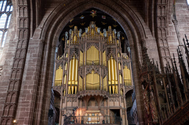 istock Cathedral pipe organ inside a tall stone archway 1382204803