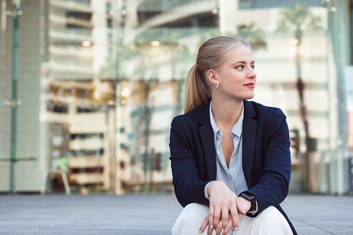 Modern  businesswoman sitting outside her office