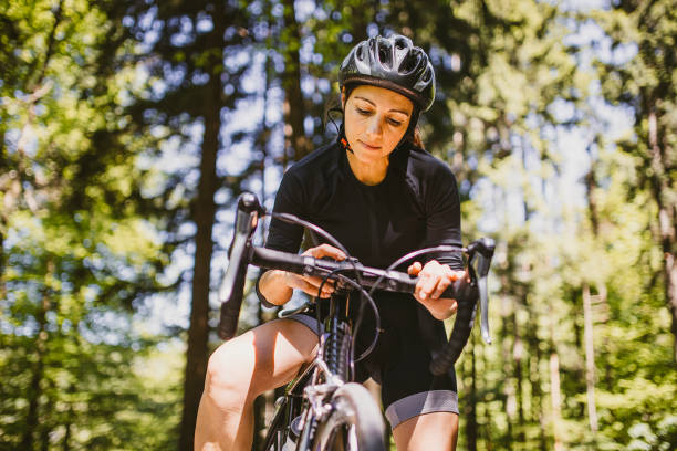 istock Woman riding a bicycle in the forest 1382205394