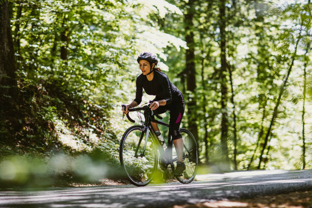 istock Woman riding a bicycle in the forest 1382205398