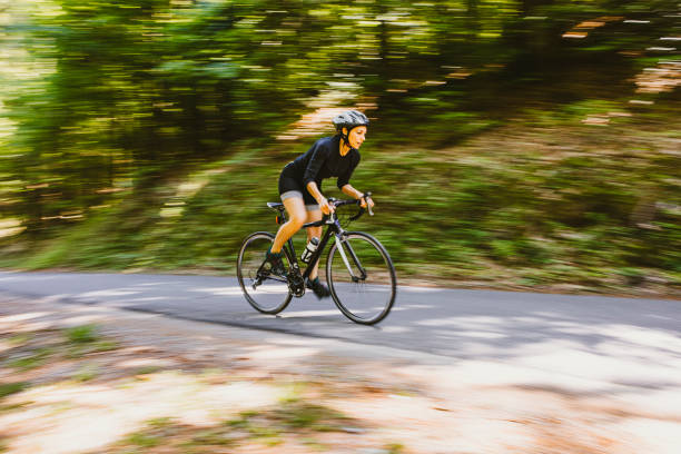istock Woman riding a bicycle in the forest 1382205426