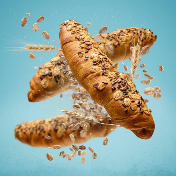 Freshly baked rolls fly in the air. stock photo