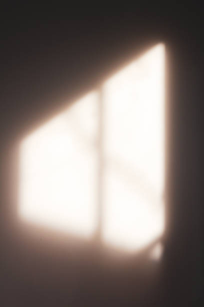 istock Window shadow , projection on a wall in the morning. Vertical background 1382218366