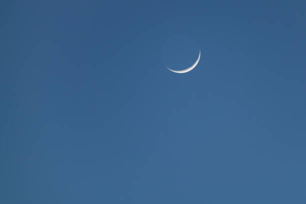 istock New waxing crescent moon setting in sky at dusk 1382232532
