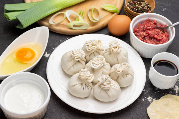 istock Raw dumplings on plate. Ingredients for making dumplings. 1382239849