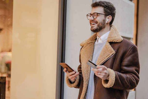 istock Young man paying online on the go 1382240454