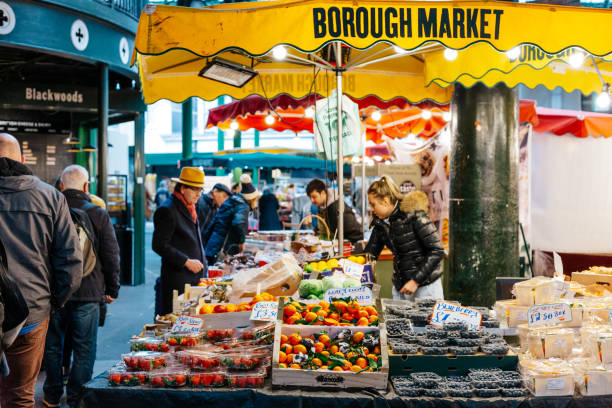 Food market employees working on stall at Borough Market, London, UK stock photo