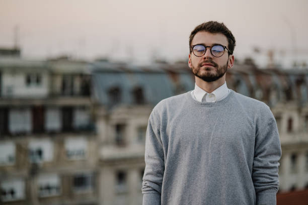 Young man eyes closed on the rooftop