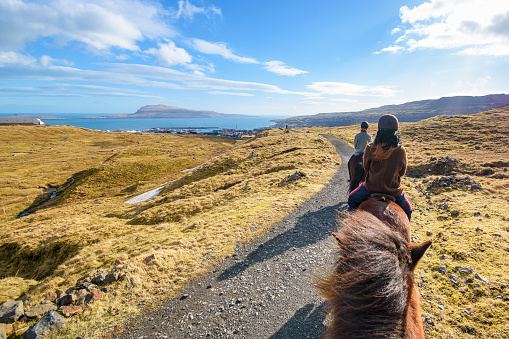 Tórshavn, Streymoy, Faroe Islands  - March 5, 2022; A group of women horseback riding in the mountains close to Tórshavn.