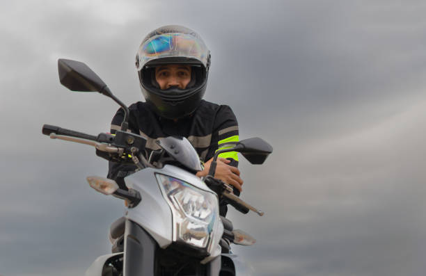 istock man with helmet on riding his motorcycle. 1382265385