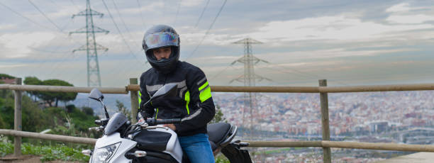 istock An anonymous man riding a motorcycle while is in a viewpoint with a city in the background 1382265389