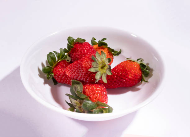 istock Strawberries served in a white bowl. Food centered with white background. 1382266760