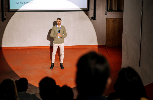 Shot of a young casually clothed man delivering a speech during a conference