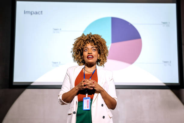 istock Casually clothed hipster woman holding a speech on a conference 1382269044