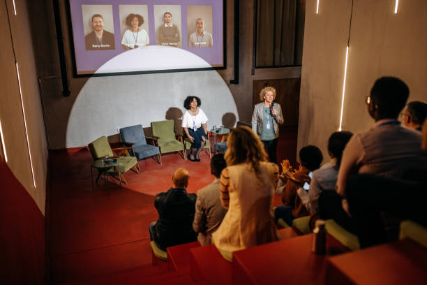 Host presenting speakers on in a conference room