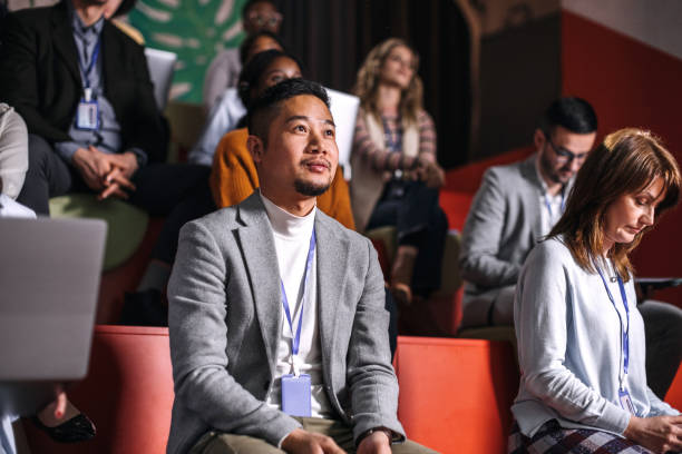 istock Young well dressed asian man attending business conference 1382270364